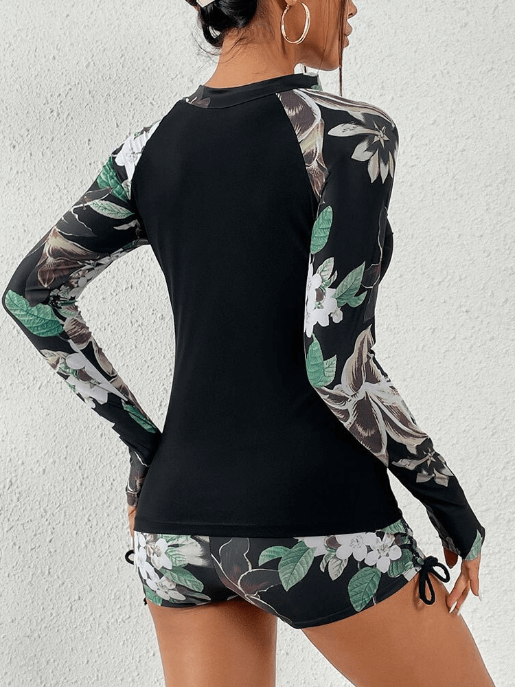 Back view of stylish split women's long sleeve surfing swimwear with floral design, ideal for beach and surfing adventures.